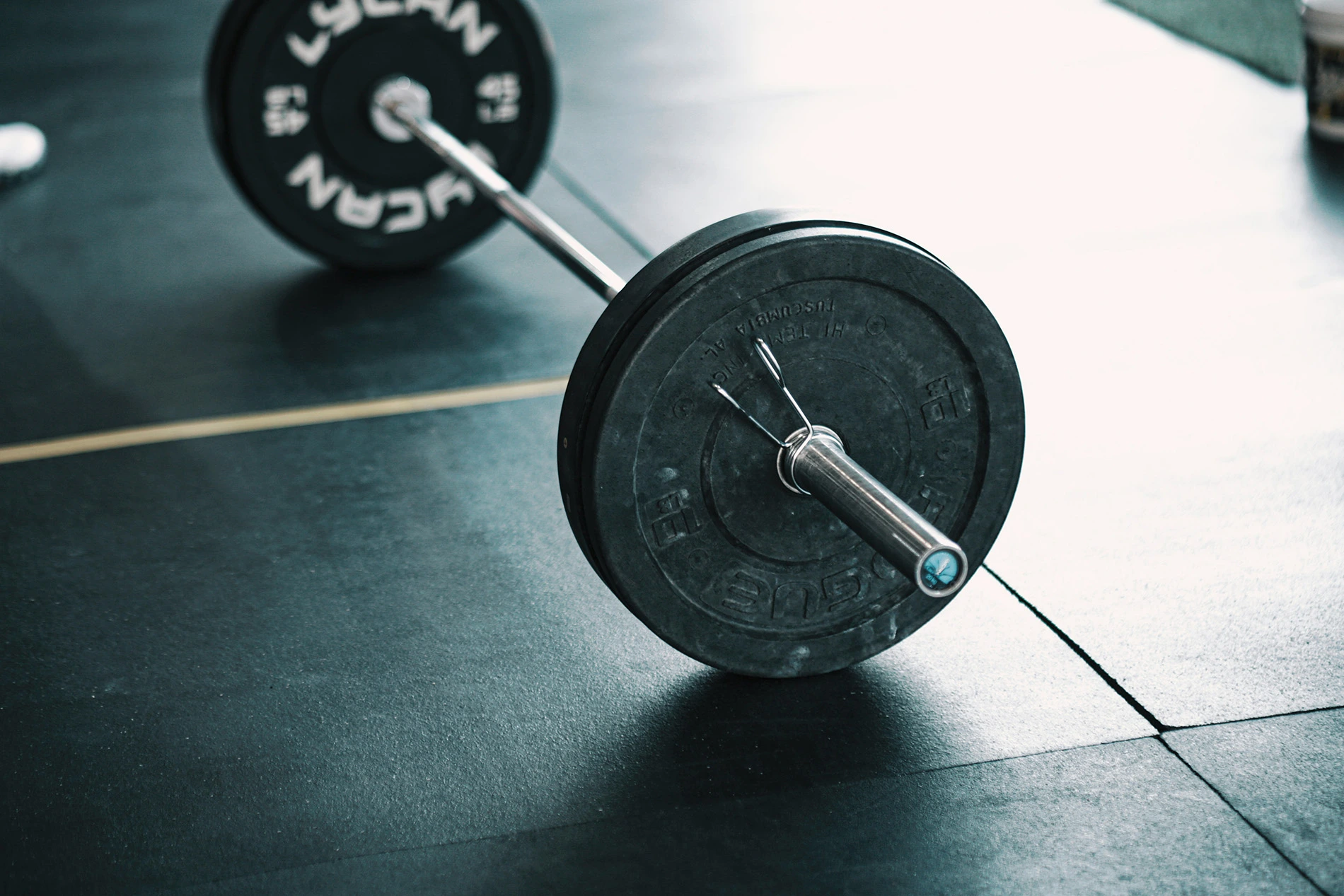 Barbell with weights in a gym on a lifting platform.